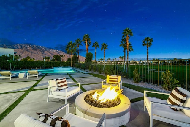 view of patio / terrace featuring a mountain view and a fire pit