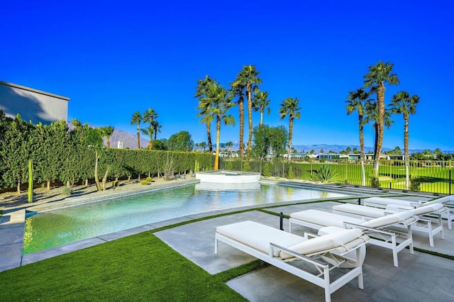 view of swimming pool with an in ground hot tub, a mountain view, and a patio area