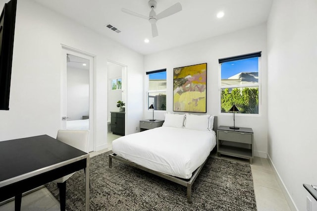 tiled bedroom with ensuite bathroom and ceiling fan