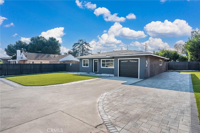 ranch-style home featuring a front lawn and a garage