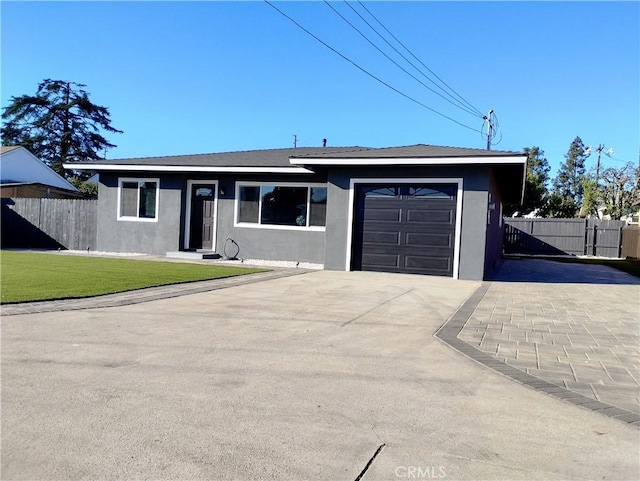 single story home with a garage and a front lawn