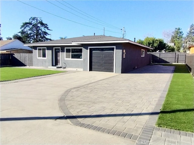 ranch-style home with a garage and a front yard