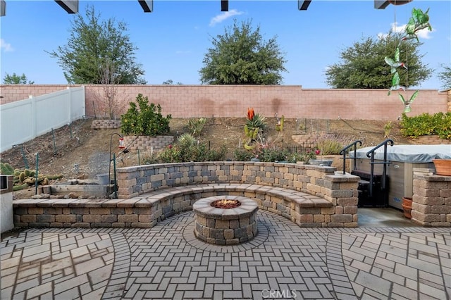 view of patio / terrace with an outdoor fire pit and a fenced backyard