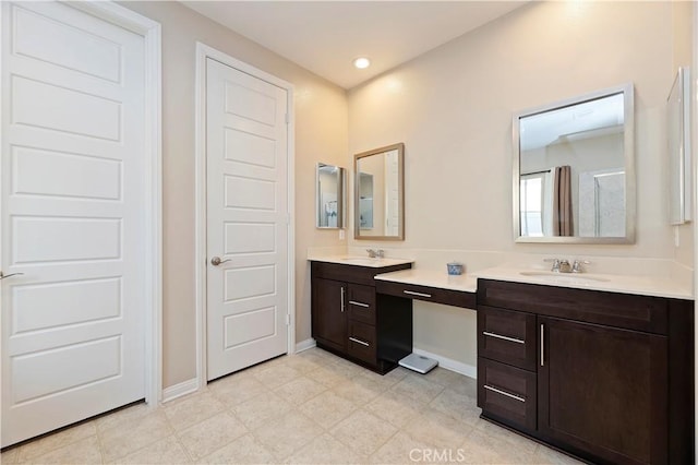 full bath featuring recessed lighting, vanity, and baseboards