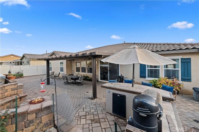 view of patio / terrace featuring area for grilling, outdoor dining area, an outdoor kitchen, and fence