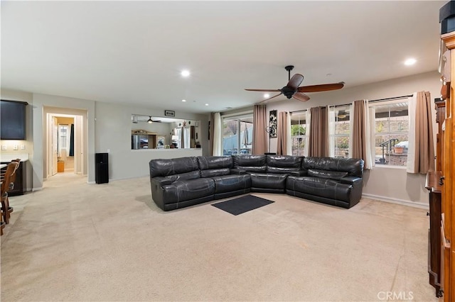 living room with a ceiling fan, recessed lighting, light carpet, and baseboards