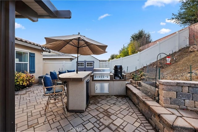 view of patio featuring area for grilling and an outdoor bar