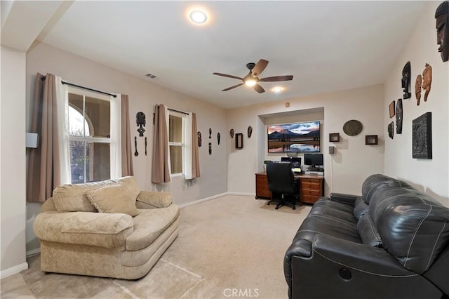 living room with light carpet, ceiling fan, visible vents, and baseboards