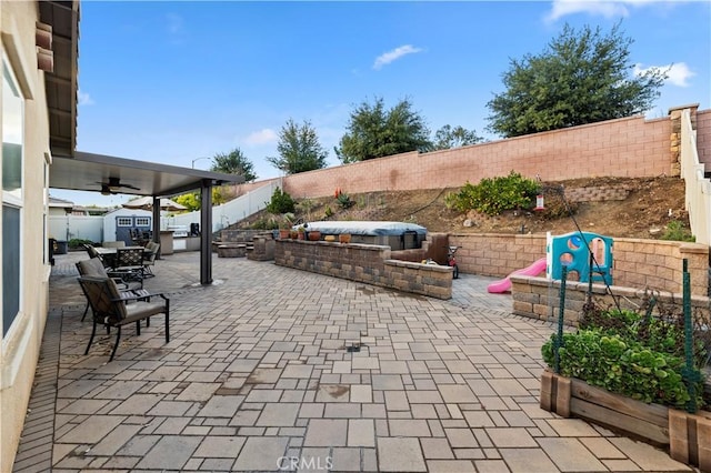 view of patio / terrace with a storage unit and ceiling fan