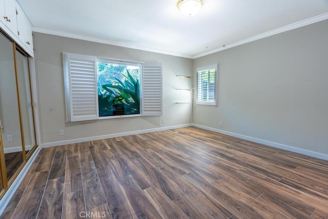 unfurnished bedroom featuring ornamental molding, dark hardwood / wood-style floors, and a closet