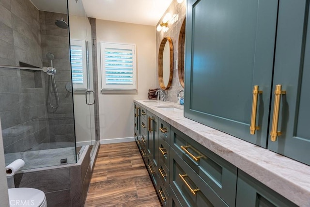 bathroom with vanity, hardwood / wood-style flooring, toilet, and walk in shower