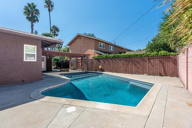 view of swimming pool with a patio area and a pergola