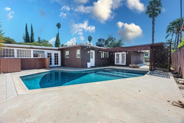 view of pool with a patio, a pergola, central AC unit, and french doors