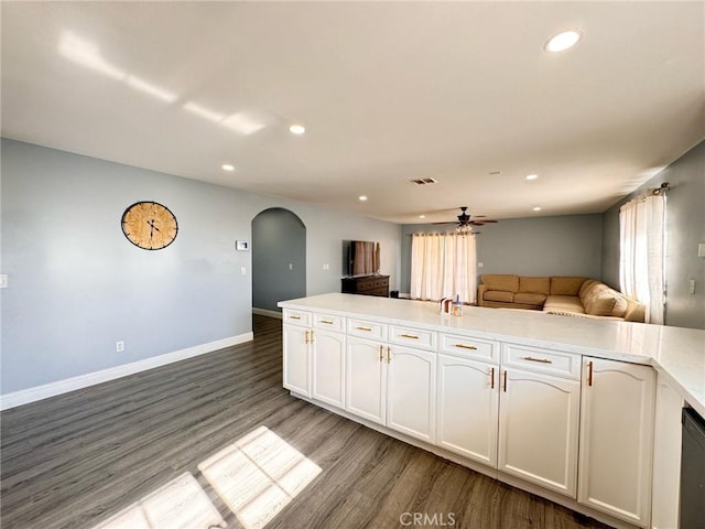 kitchen with light hardwood / wood-style floors, white cabinets, and ceiling fan