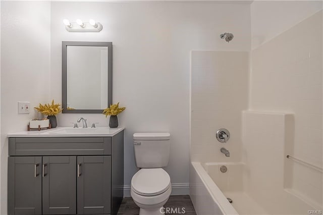 full bathroom with hardwood / wood-style flooring, toilet, vanity, and bathing tub / shower combination