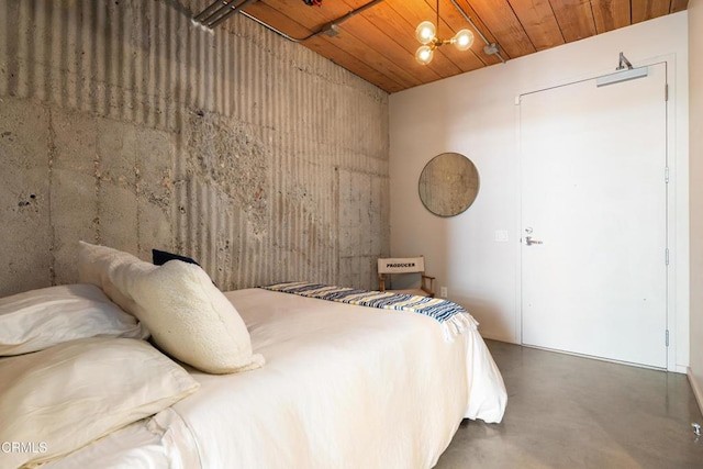 bedroom with concrete flooring and wood ceiling