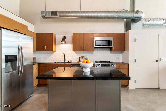 kitchen with decorative backsplash, a center island, sink, and appliances with stainless steel finishes