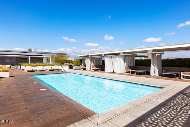 view of swimming pool featuring outdoor lounge area and a patio area