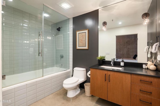 full bathroom with tile patterned floors, toilet, vanity, and combined bath / shower with glass door