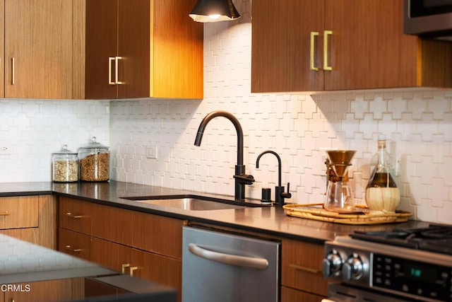 kitchen with dishwasher, sink, backsplash, dark stone countertops, and stove