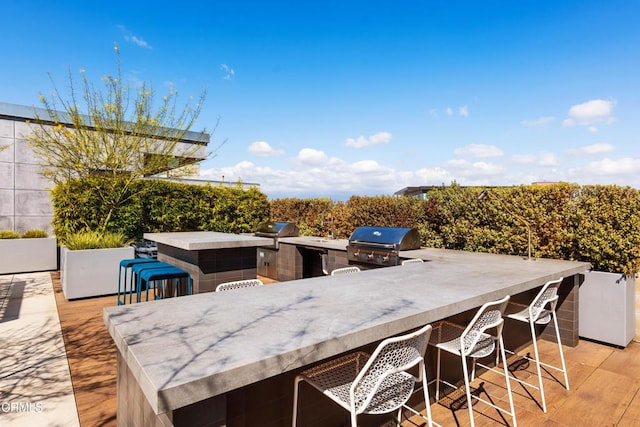 view of patio / terrace with area for grilling and a bar