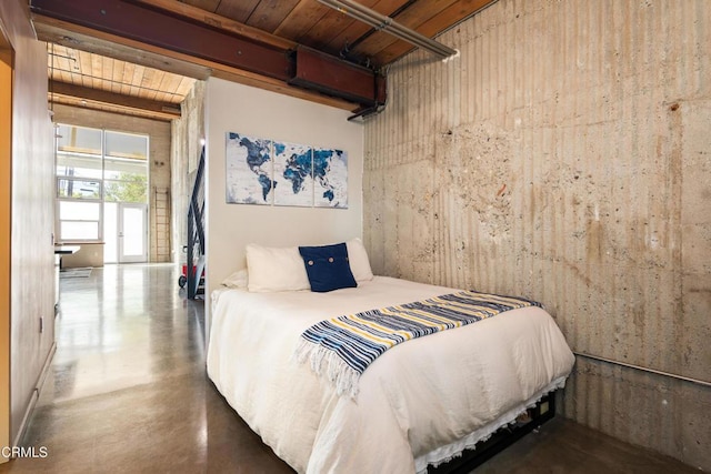 bedroom featuring concrete floors