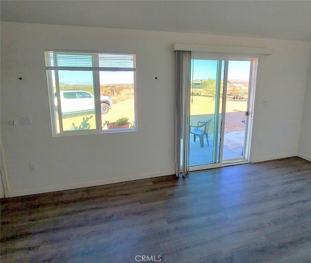 spare room with dark hardwood / wood-style floors