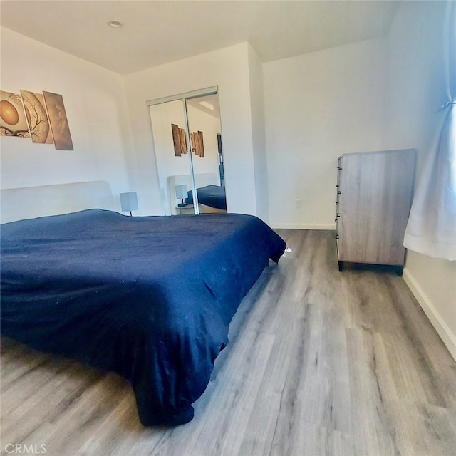 56133 Jesse Rd, Landers, CA 92285 - bedroom featuring baseboards, wood finished floors, and a closet