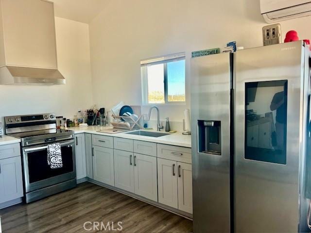 kitchen featuring appliances with stainless steel finishes, wall chimney exhaust hood, dark wood-type flooring, sink, and a wall mounted AC