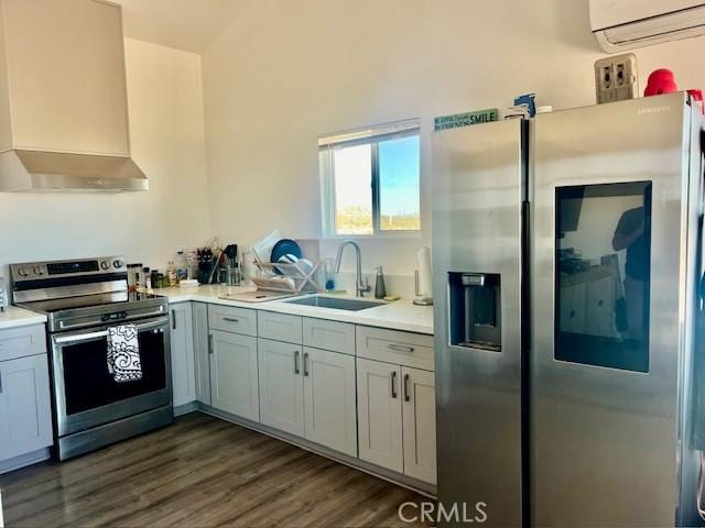 56133 Jesse Rd, Landers, CA 92285 - kitchen featuring stainless steel appliances, a sink, wall chimney exhaust hood, an AC wall unit, and light countertops