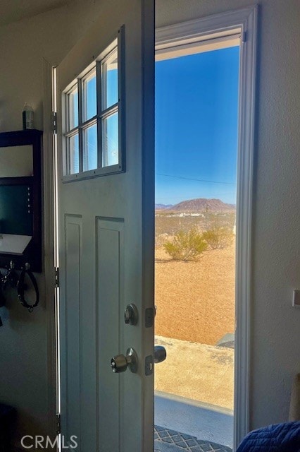 doorway with a healthy amount of sunlight and a mountain view