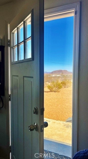 56133 Jesse Rd, Landers, CA 92285 - doorway to outside featuring a mountain view and a textured wall