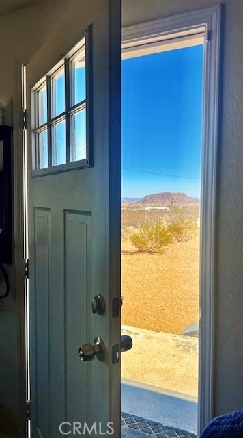 56133 Jesse Rd, Landers, CA 92285 - entryway featuring a mountain view, a textured wall, and carpet