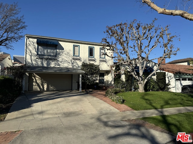 view of front of house featuring a garage and a front yard