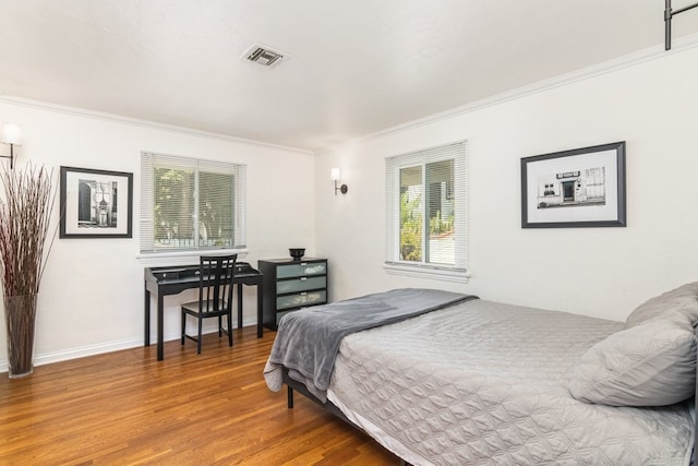 bedroom featuring hardwood / wood-style floors and ornamental molding