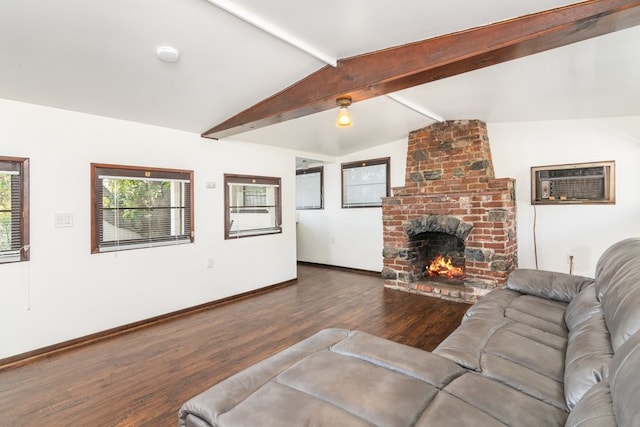 living room featuring a brick fireplace, dark hardwood / wood-style flooring, vaulted ceiling with beams, and a wall mounted air conditioner