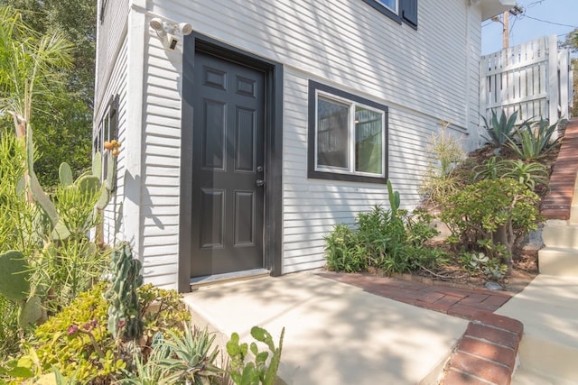 view of exterior entry featuring a patio