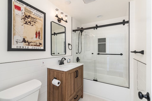 full bathroom featuring shower / bath combination with glass door, tile patterned flooring, vanity, tile walls, and toilet