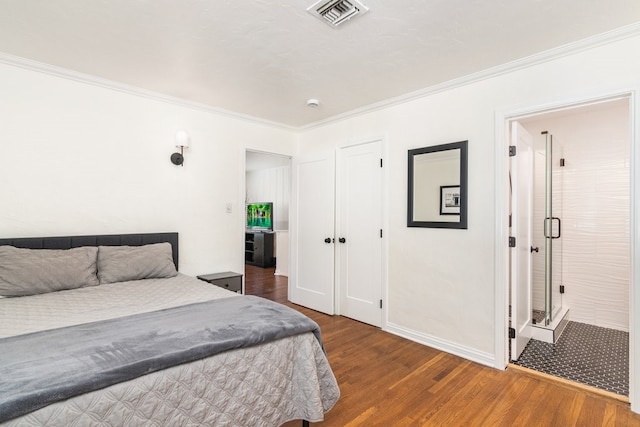 bedroom with ornamental molding and hardwood / wood-style floors