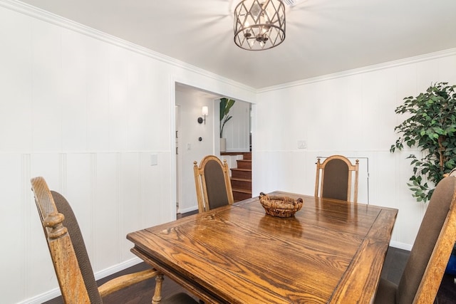 dining space featuring hardwood / wood-style flooring, ornamental molding, and a chandelier