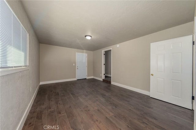 spare room featuring dark hardwood / wood-style flooring