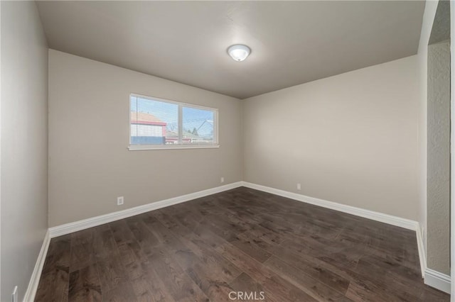 unfurnished room featuring dark hardwood / wood-style flooring