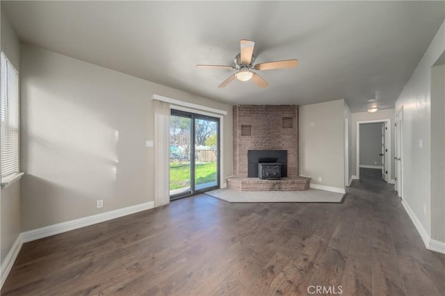 unfurnished living room featuring ceiling fan and dark hardwood / wood-style flooring