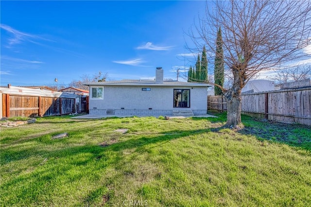 rear view of property featuring a yard