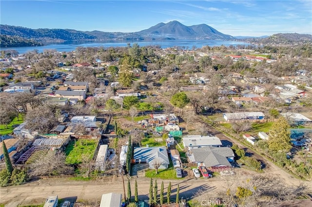 drone / aerial view with a water and mountain view