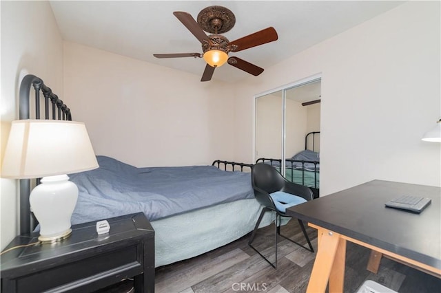 bedroom featuring ceiling fan, wood-type flooring, and a closet