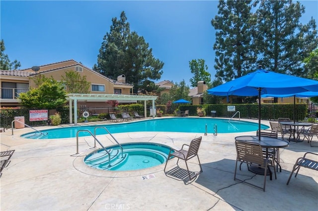 view of pool with a pergola, a community hot tub, and a patio