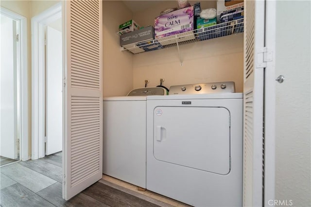 washroom featuring independent washer and dryer and wood-type flooring