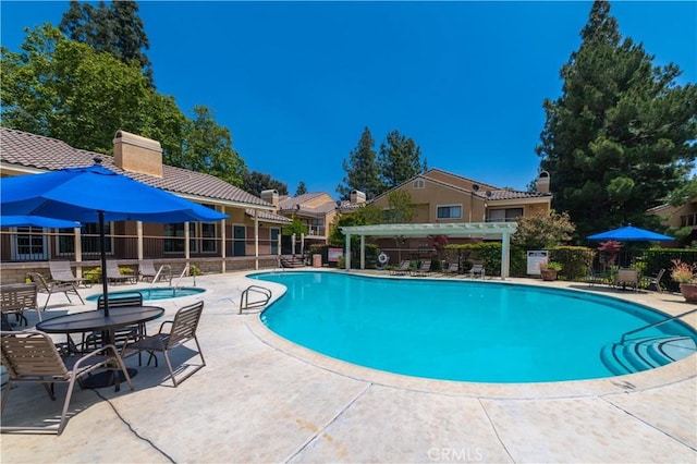 view of swimming pool featuring a pergola and a patio