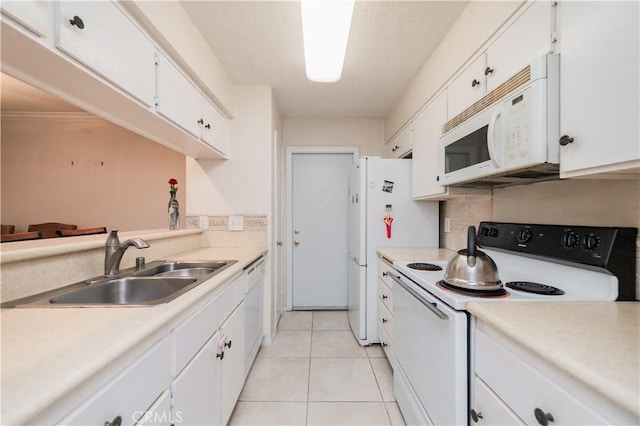 kitchen featuring white cabinets, sink, white appliances, and light tile patterned flooring